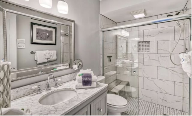 bathroom with vanity, toilet, and an enclosed shower