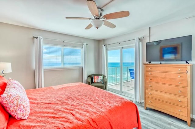 bedroom with access to outside, ceiling fan, and hardwood / wood-style flooring