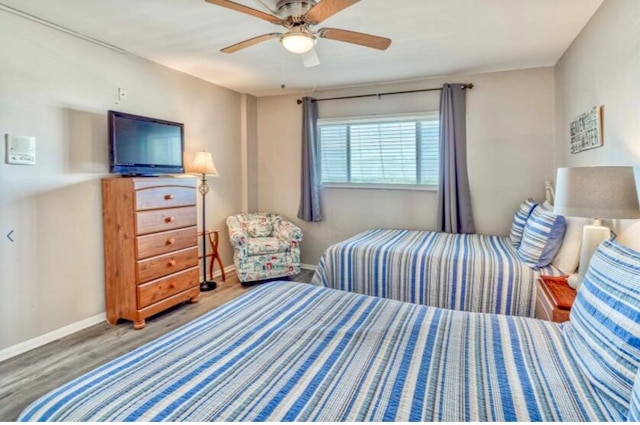 bedroom with hardwood / wood-style floors and ceiling fan