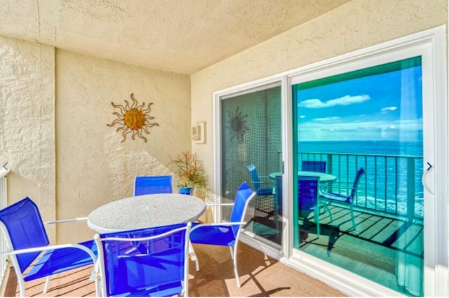 balcony featuring a water view