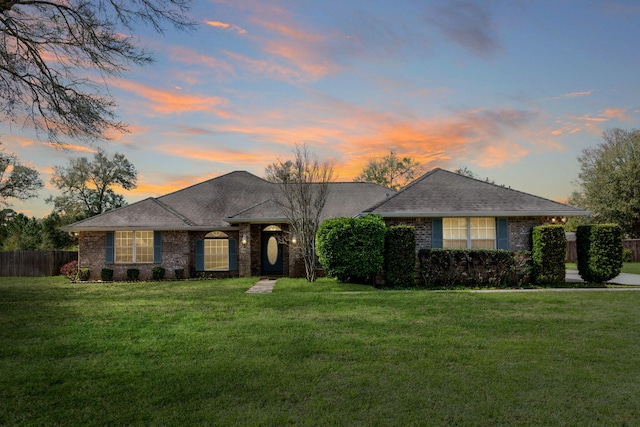 ranch-style house with a yard