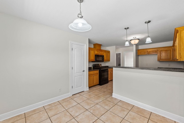 kitchen featuring pendant lighting, light tile patterned floors, and black appliances