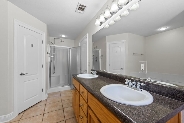 bathroom featuring tile patterned flooring, vanity, and an enclosed shower