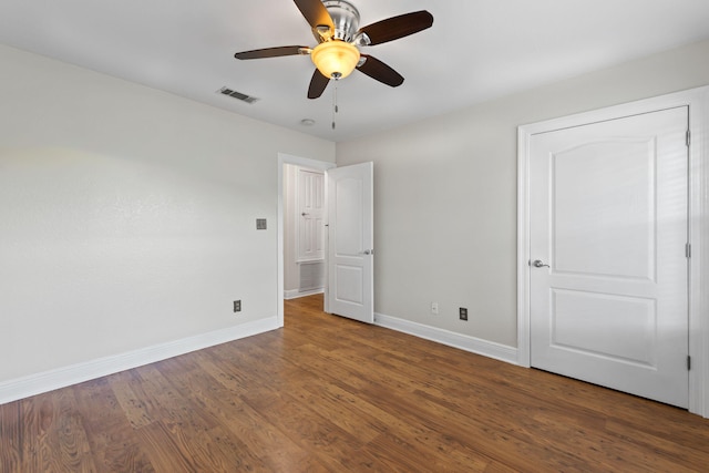 unfurnished bedroom with ceiling fan and dark hardwood / wood-style floors