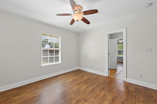empty room with hardwood / wood-style flooring and ceiling fan