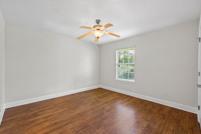 empty room featuring ceiling fan and dark wood-type flooring