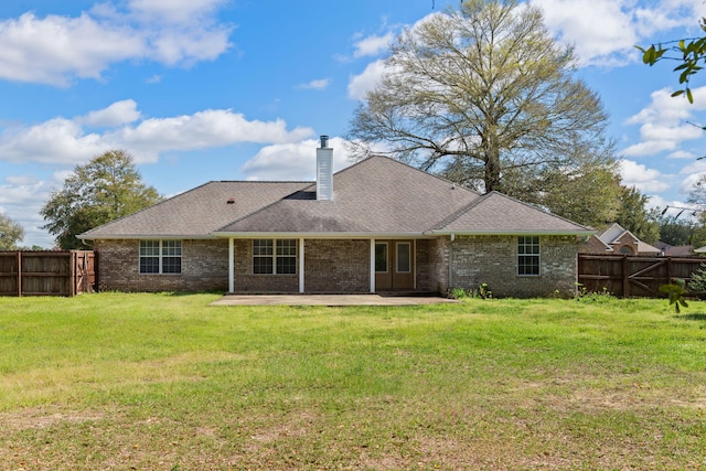 back of property featuring a yard and a patio