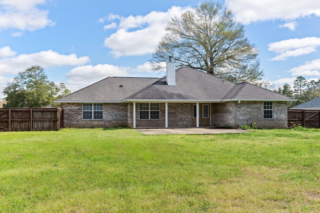back of property featuring a yard and a patio