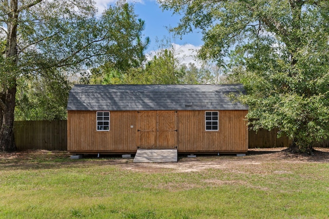 view of outbuilding featuring a lawn