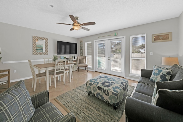 living room featuring french doors, a textured ceiling, light tile patterned floors, and ceiling fan