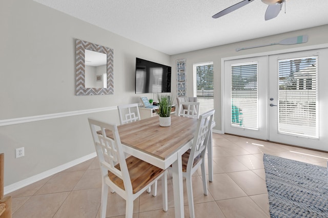 tiled dining area featuring french doors, a textured ceiling, and ceiling fan