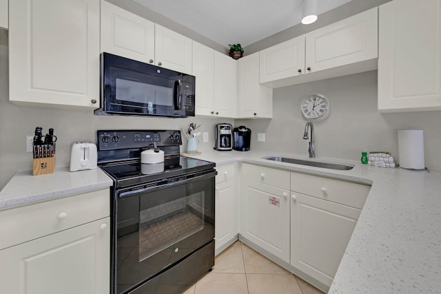 kitchen featuring sink, white cabinetry, and black appliances