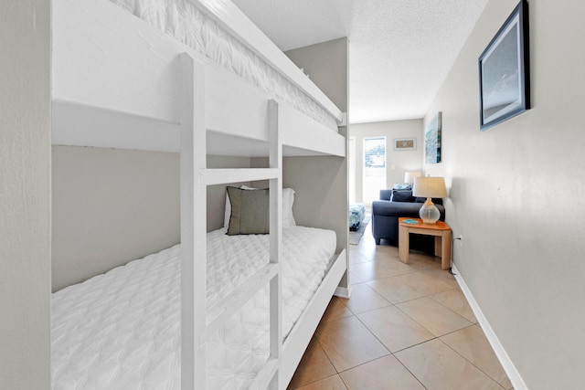 tiled bedroom with a textured ceiling