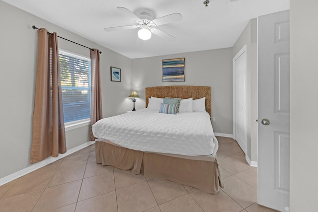 tiled bedroom with ceiling fan