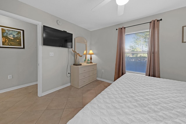 tiled bedroom featuring ceiling fan