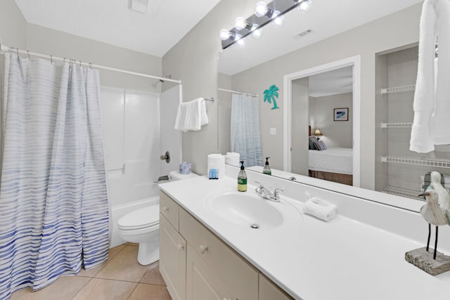 full bathroom with tile patterned floors, a textured ceiling, toilet, shower / bath combo with shower curtain, and vanity