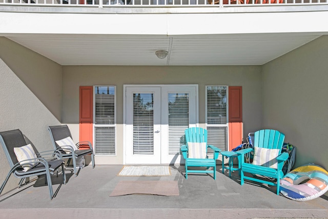 view of patio with french doors and a balcony