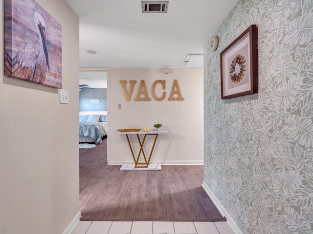 hall featuring wood-type flooring and a textured ceiling