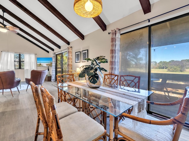 dining space featuring beamed ceiling, plenty of natural light, hardwood / wood-style flooring, and high vaulted ceiling