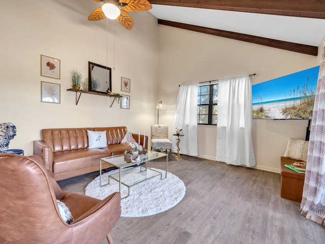 living room with beam ceiling, light hardwood / wood-style floors, high vaulted ceiling, and ceiling fan