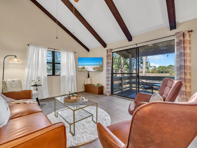 living room with beam ceiling, high vaulted ceiling, and light hardwood / wood-style flooring