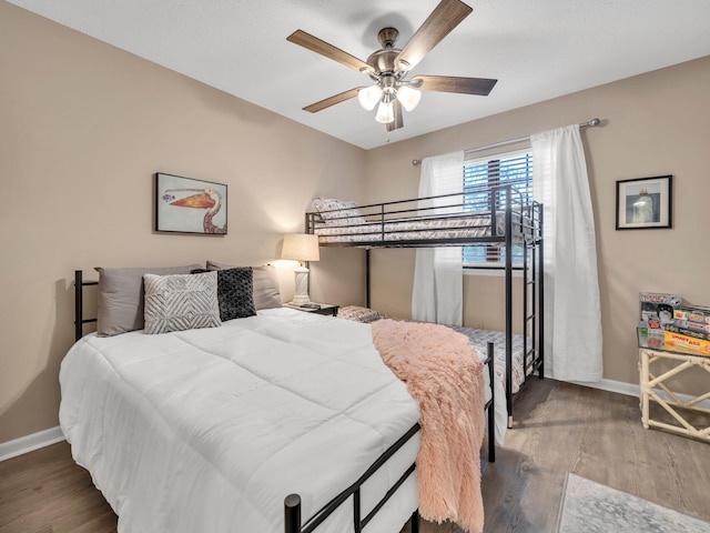 bedroom with ceiling fan and hardwood / wood-style floors