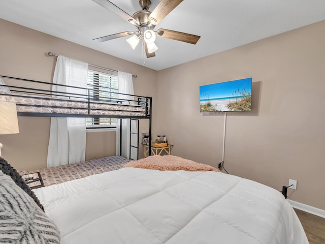 bedroom with ceiling fan and hardwood / wood-style floors