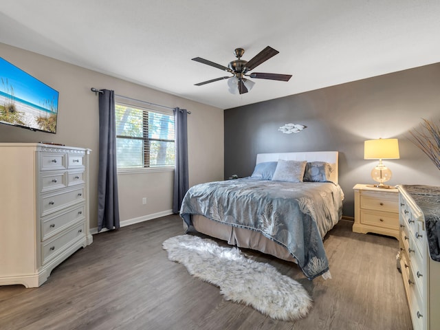 bedroom with hardwood / wood-style floors and ceiling fan