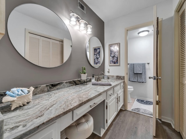 bathroom featuring hardwood / wood-style floors, vanity, and toilet