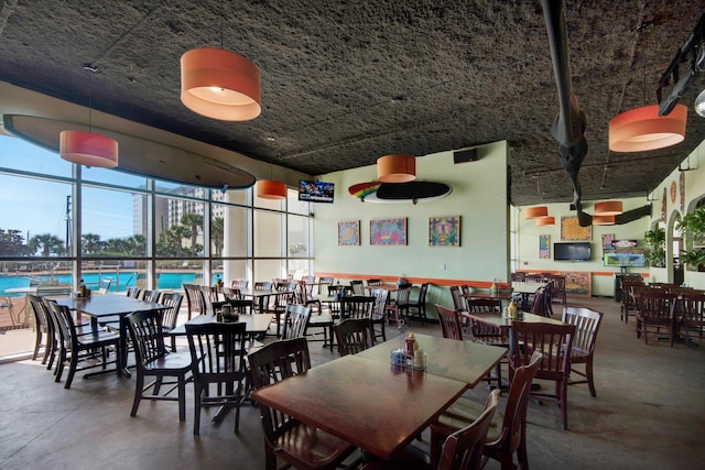 dining area featuring concrete floors