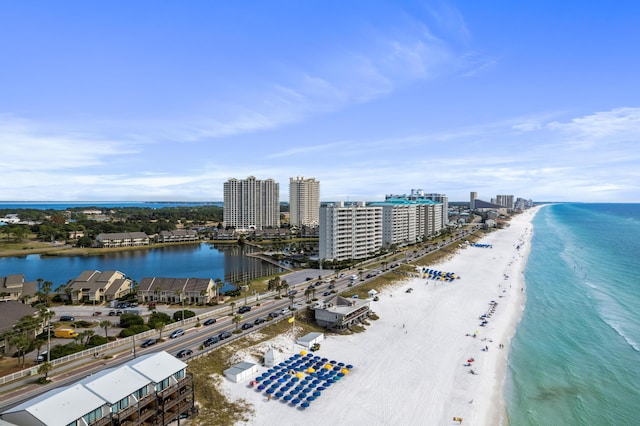 drone / aerial view with a water view and a beach view