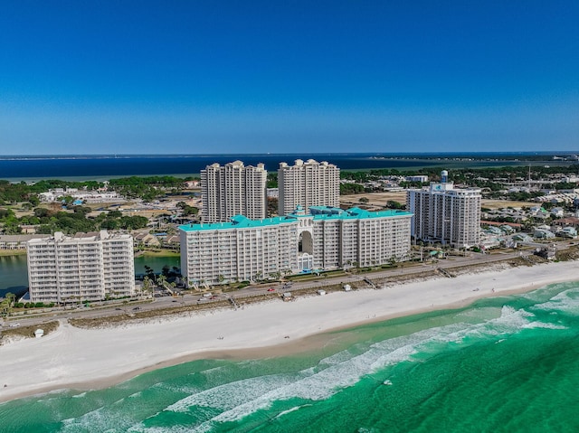 bird's eye view featuring a water view and a beach view