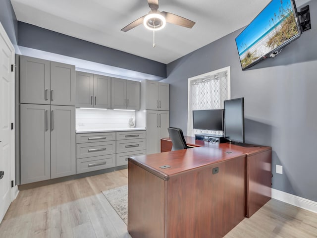 home office featuring light hardwood / wood-style flooring and ceiling fan