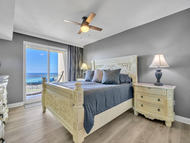 bedroom featuring access to exterior, ceiling fan, a water view, and light hardwood / wood-style floors