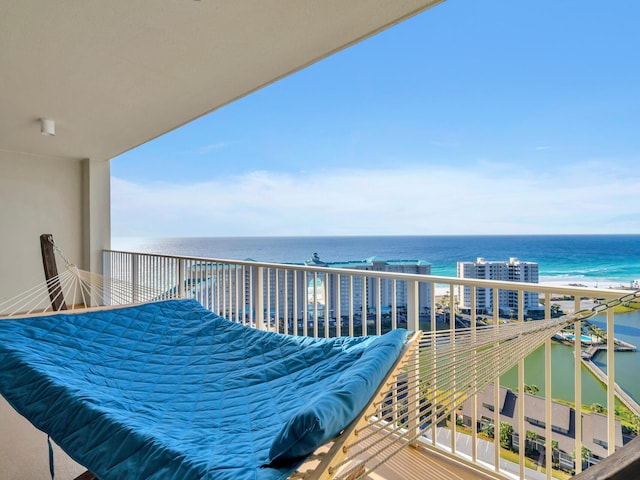 balcony featuring a water view and a beach view