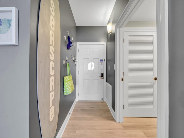 doorway to outside with light wood-type flooring