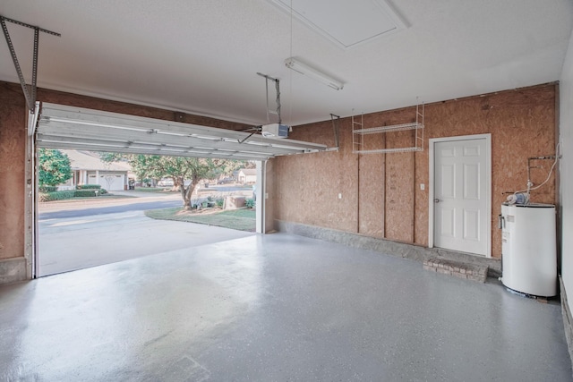 garage featuring a garage door opener and water heater