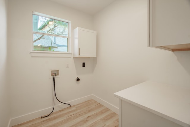 clothes washing area featuring cabinets, hookup for a washing machine, and light wood-type flooring