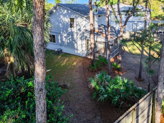 view of yard with central AC unit and a sunroom