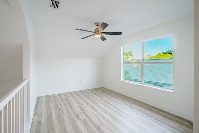 bonus room featuring light hardwood / wood-style floors, vaulted ceiling, a wealth of natural light, and ceiling fan