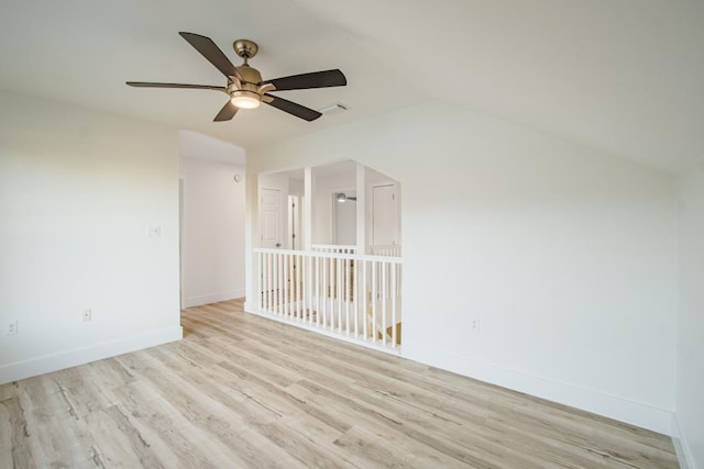 spare room featuring ceiling fan, light hardwood / wood-style flooring, and vaulted ceiling