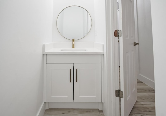 bathroom featuring hardwood / wood-style flooring and vanity