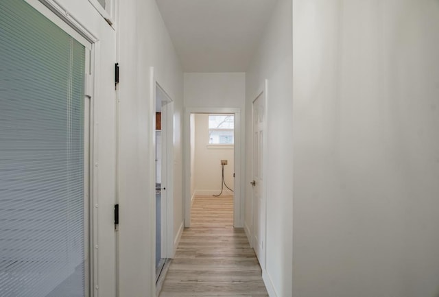 corridor with light wood-type flooring