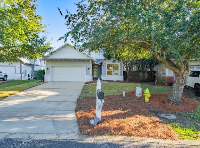 view of front of property with a front yard and a garage