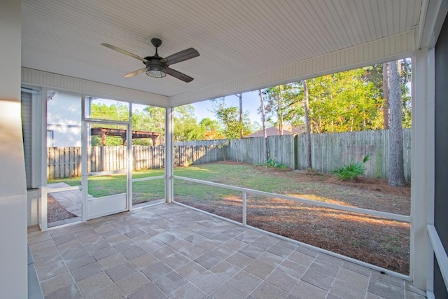 unfurnished sunroom featuring ceiling fan