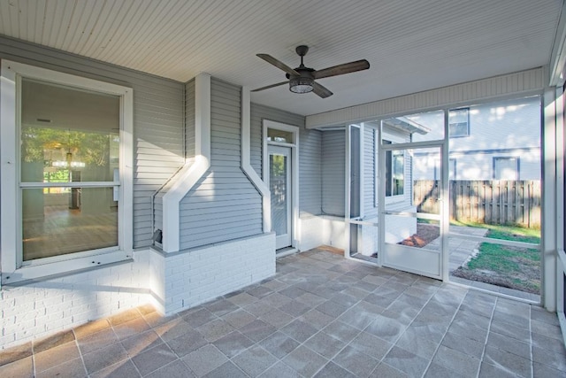 unfurnished sunroom featuring ceiling fan and wooden ceiling