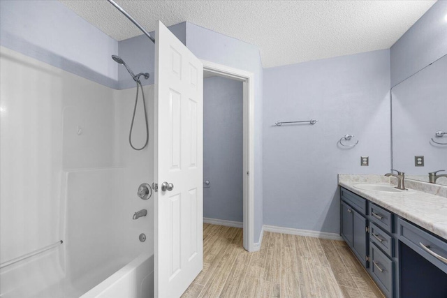 439 Northview Ln, Crestview, FL 32536 - full bath with a textured ceiling, wood finished floors, vanity, baseboards, and tub / shower combination