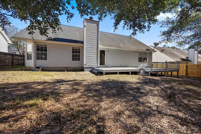 439 Northview Ln, Crestview, FL 32536 - back of house with a chimney, a fenced backyard, and a wooden deck