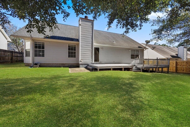 439 Northview Ln, Crestview, FL 32536 - back of house featuring a yard, a deck, a chimney, and a fenced backyard
