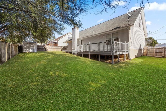 439 Northview Ln, Crestview, FL 32536 - back of property featuring a lawn, a deck, a fenced backyard, and a storage unit